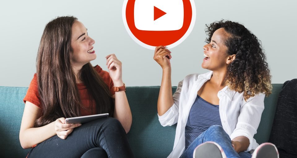 Women holding a YouTube icon